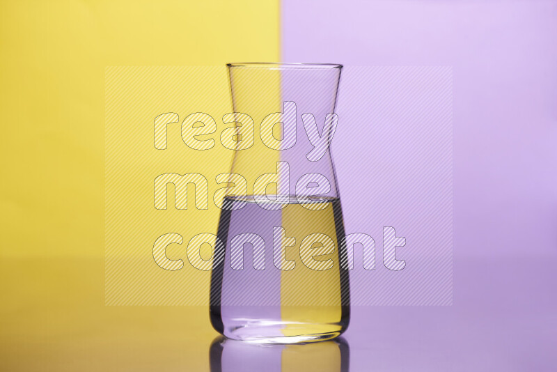 The image features a clear glassware filled with water, set against yellow and light purple background