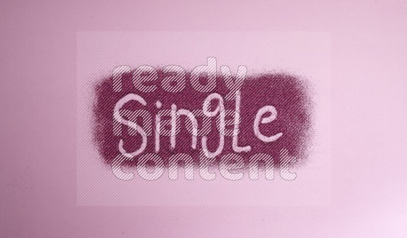 A word written with pink glitter on pink background