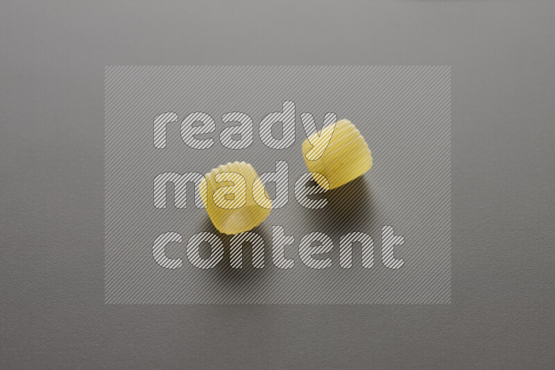 Big rings pasta on grey background