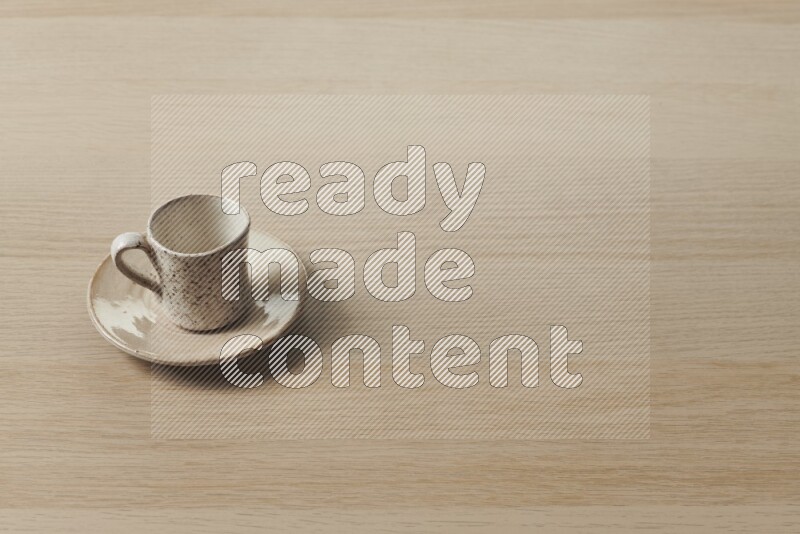A pottery cup on light wooden background