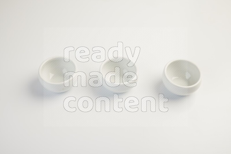 white ceramic round sauce dish on white countertop