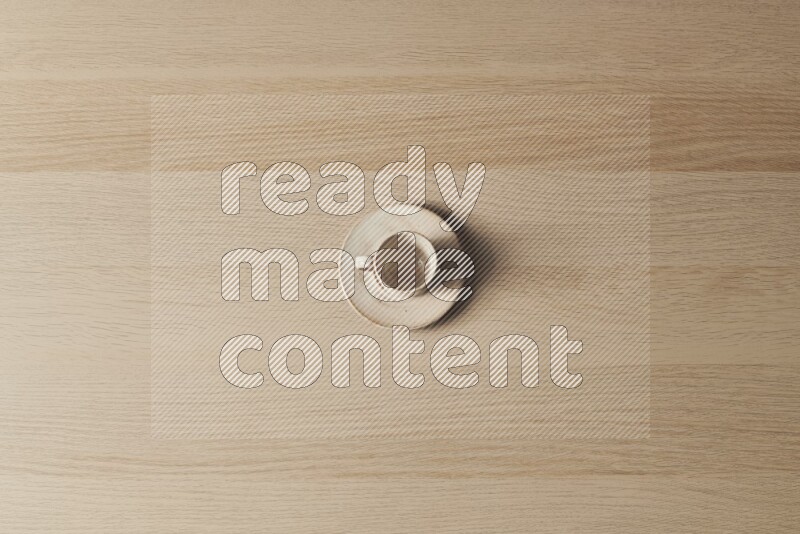 A pottery cup on light wooden background