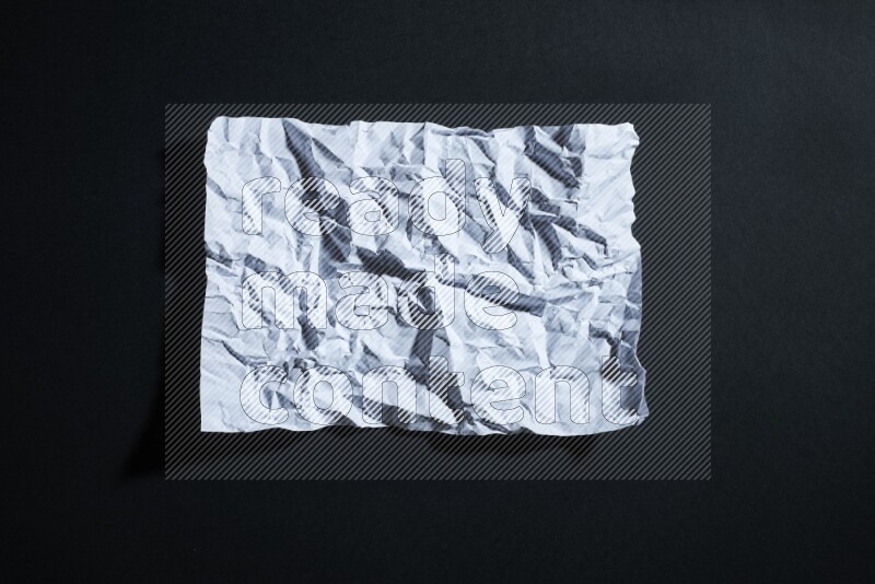 White paper sheet on black background