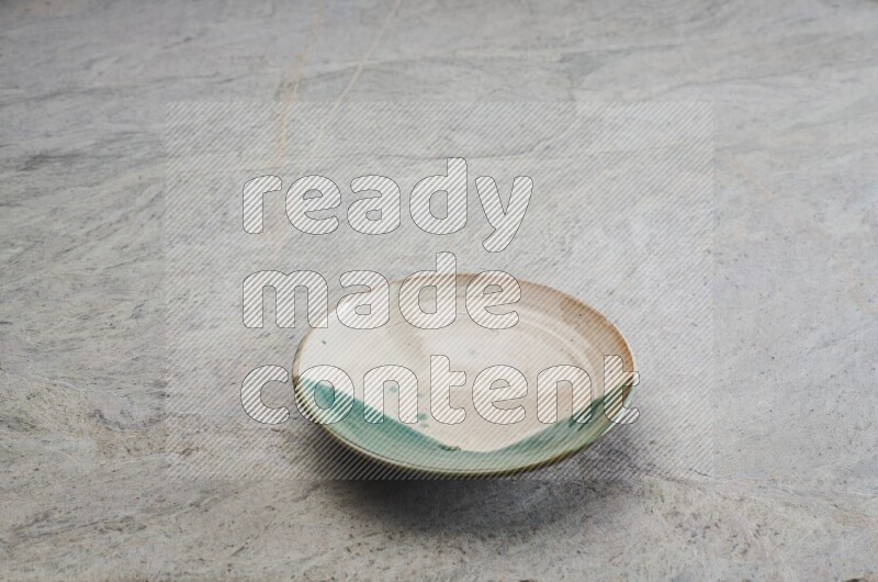 Decorative Pottery Plate On Grey Marble Flooring