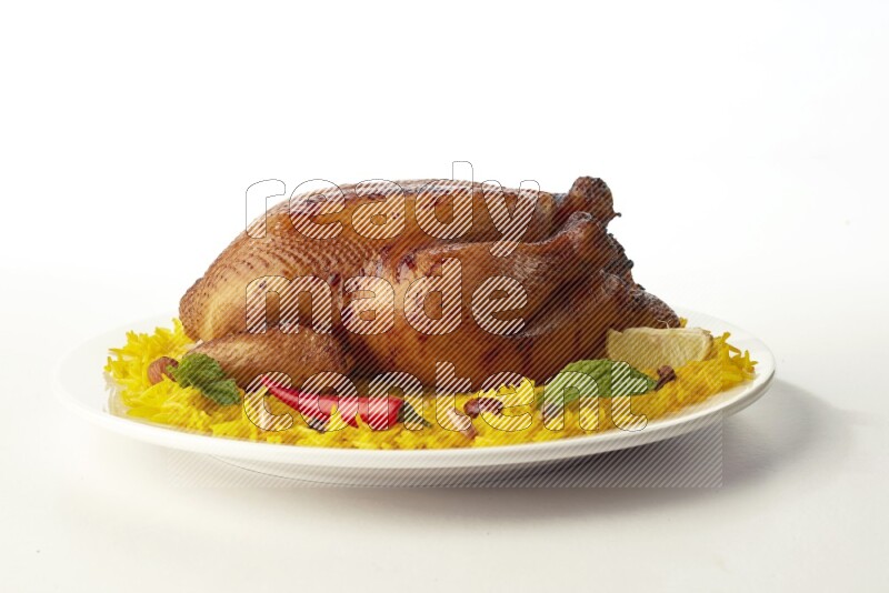 yellow  basmati Rice with  whole roasted chicken on a white rounded plate direct on white background
