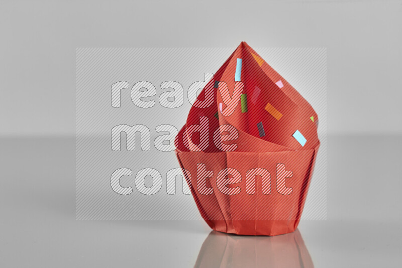 Origami cupcake on grey background