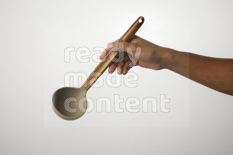 Male Hand Holding ladle on white background
