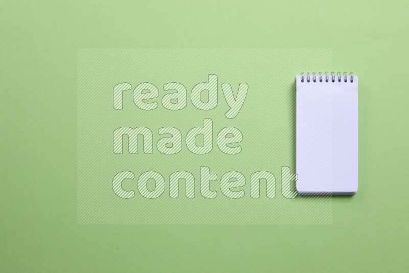 A blank open notebook on green background