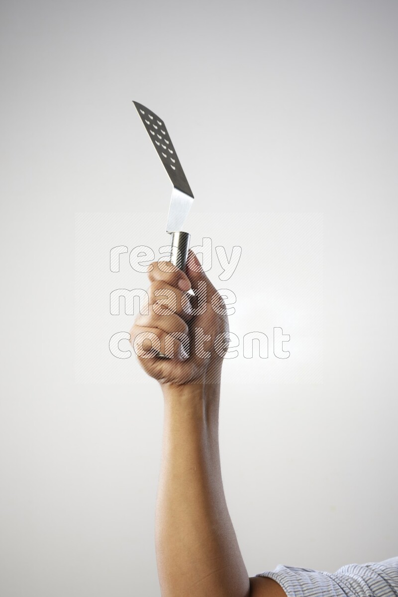 Male Hand Holding Burger Flipper on white background