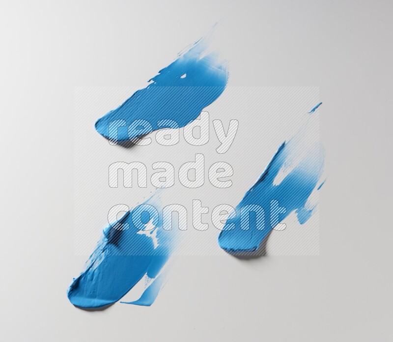Blue painting knife strokes on white background