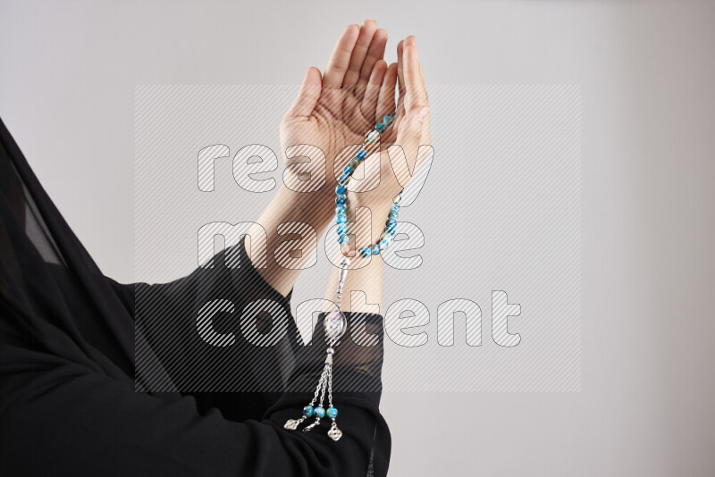 Woman hands holding praying beads (sebha) in different positions