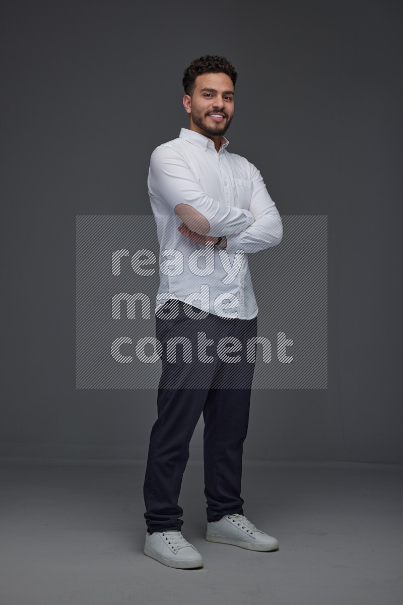 A man wearing smart casual making multi stand poses  eye level on a gray background