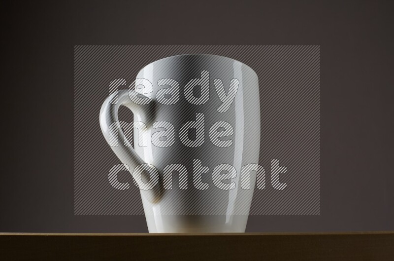 Low angle shot of a white cup on grey background