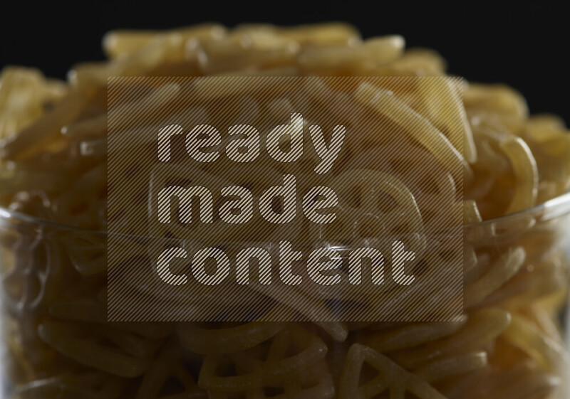 Snacks in a glass jar on black background