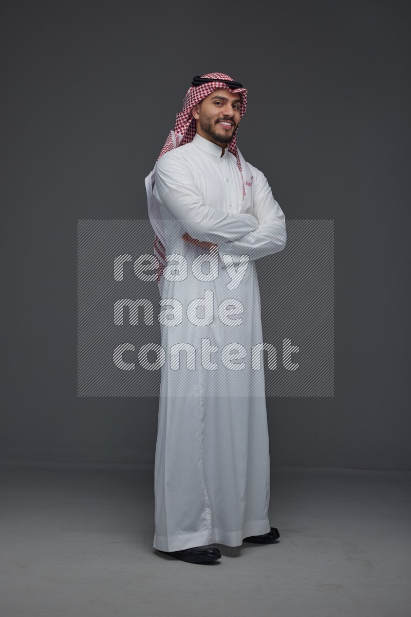 A Saudi man wearing Thobe and Shmagh standing in different poses eye level on a gray background