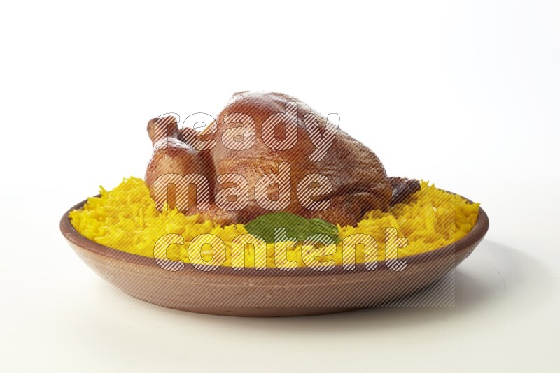 yellow basmati Rice with whole roasted chicken  on a pottery plate  direct  on white background