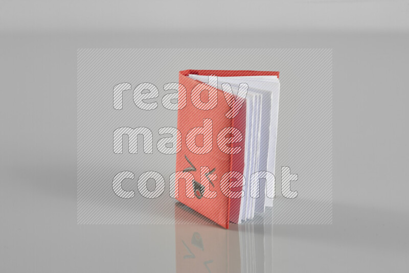 Origami book on grey background