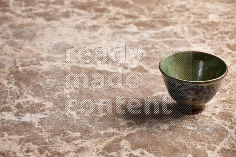 A decorative pottery bowl on beige marble background