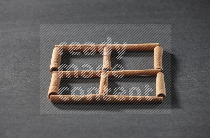 4 squares of cinnamon sticks on black flooring