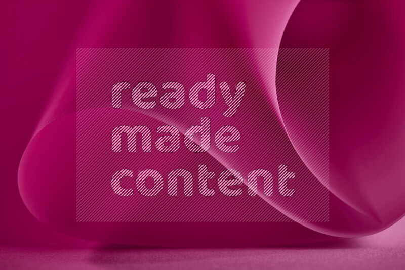 An abstract art piece displaying smooth curves in pink gradients created by colored light