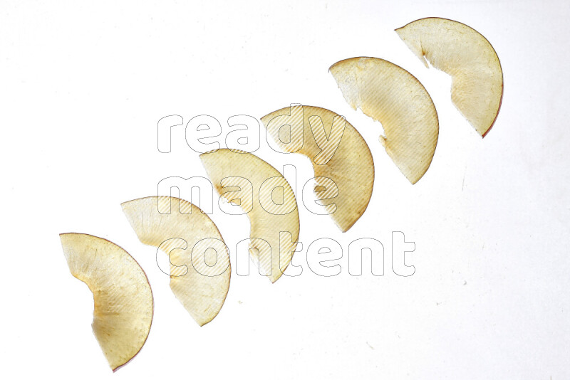 Peach slices on illuminated white background