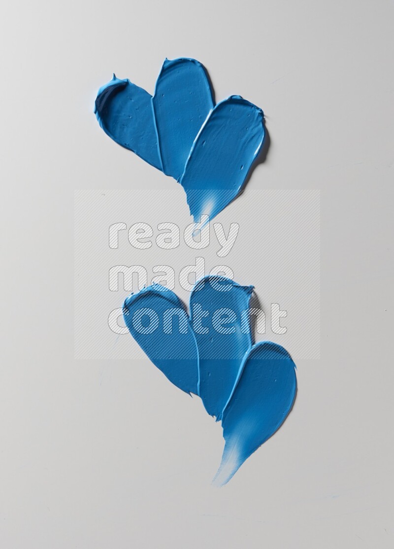 Blue painting knife strokes on white background
