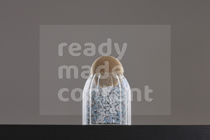 Buttons in a glass jar on black background