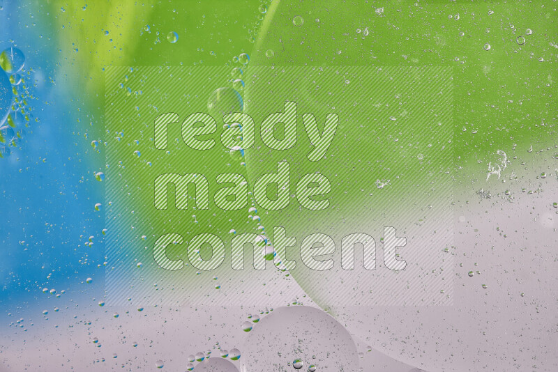 Close-ups of abstract oil bubbles on water surface in shades of white, green and blue