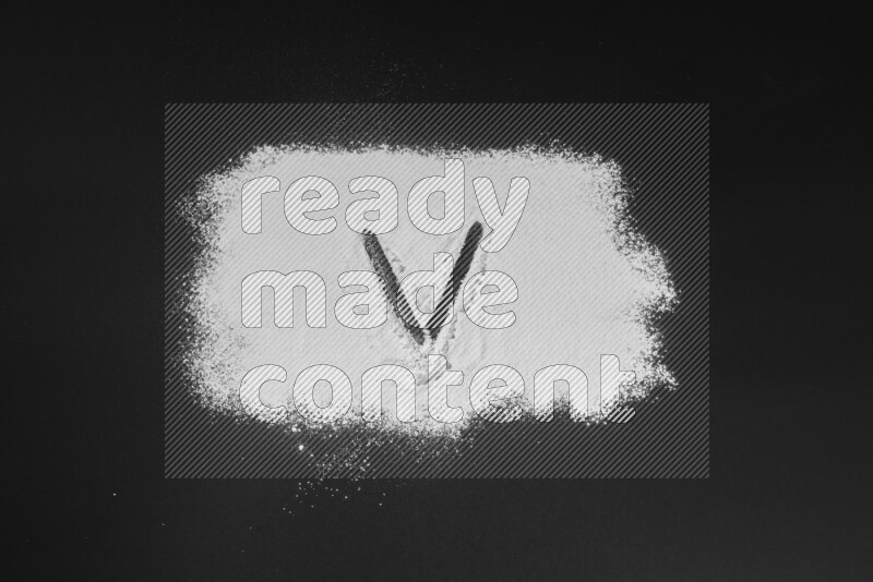 Alphabets written with powder on black background