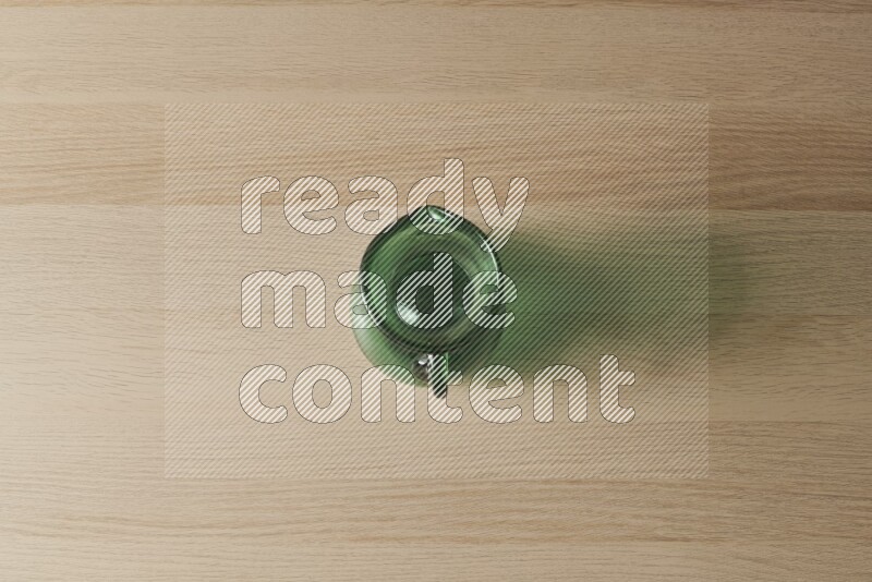A colored glass jug on light wooden background