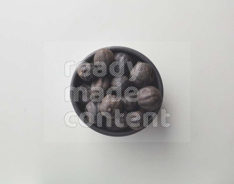 Top-view shot of dried lime (loomi) in a container on white background