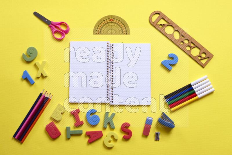 Different school supplies on yellow background