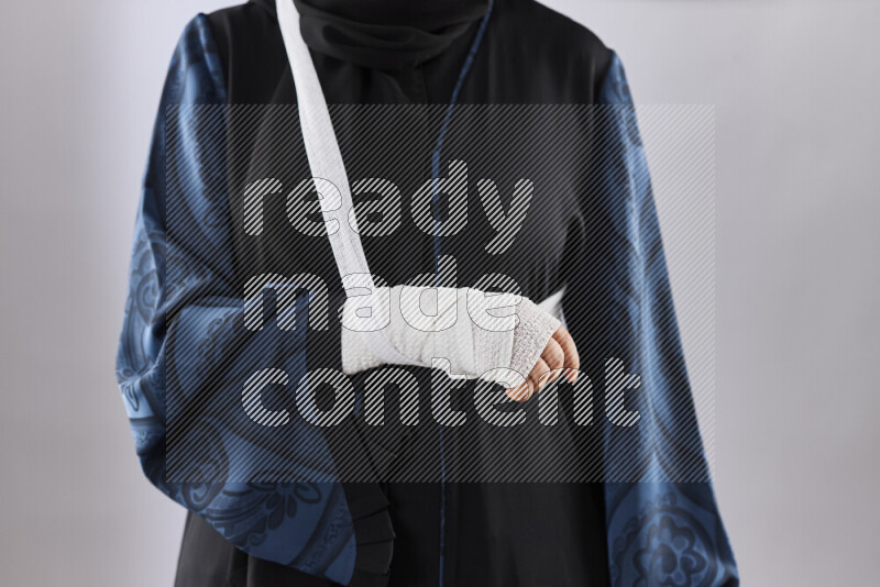 Woman with a bandaged hand and arm sling