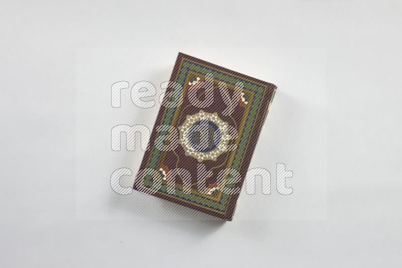 Quran with a prayer beads on white background