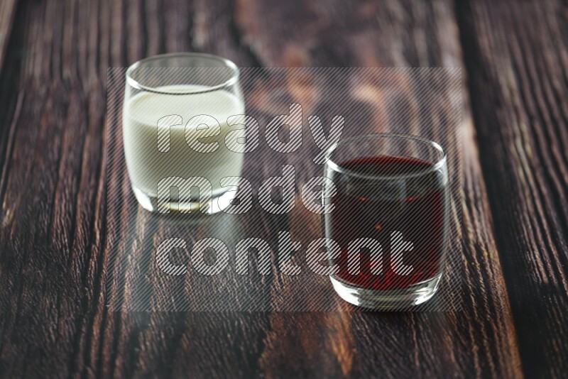 Cold drinks in a glass cup such as water, tamarind, qamar eldin, sobia, milk and hibiscus on wooden background
