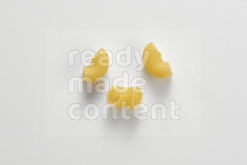Elbow pasta on white background