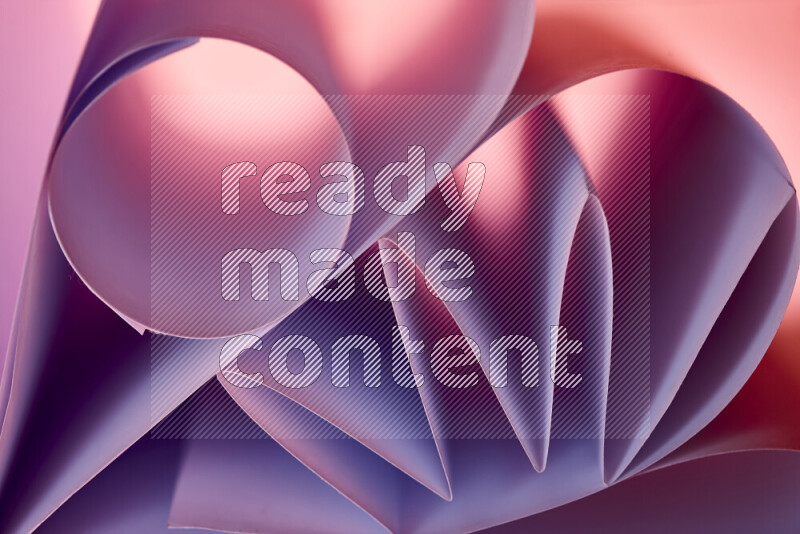 An artistic display of paper folds creating a harmonious blend of geometric shapes, highlighted by soft lighting in purple tones