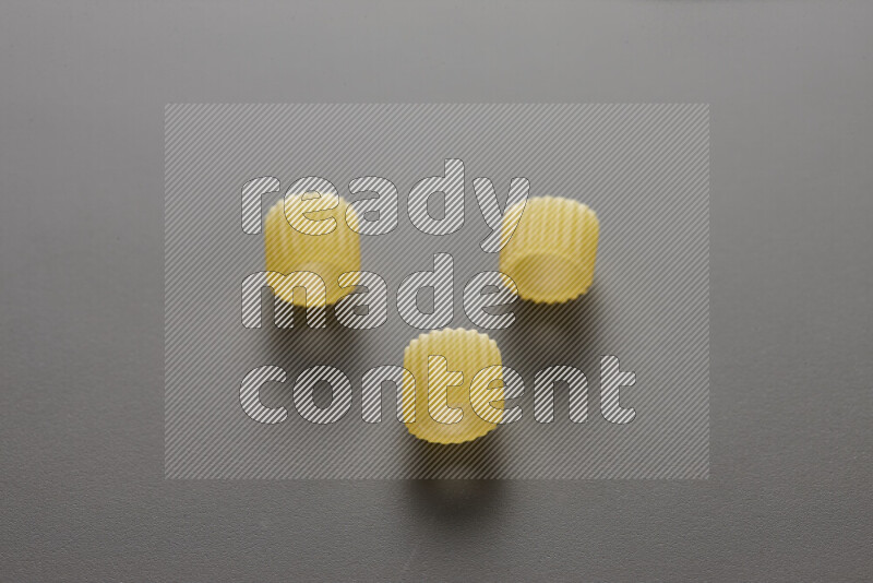 Big rings pasta on grey background
