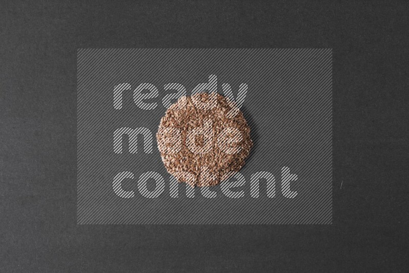 Flax Seeds in a circle shape on a black Flooring
