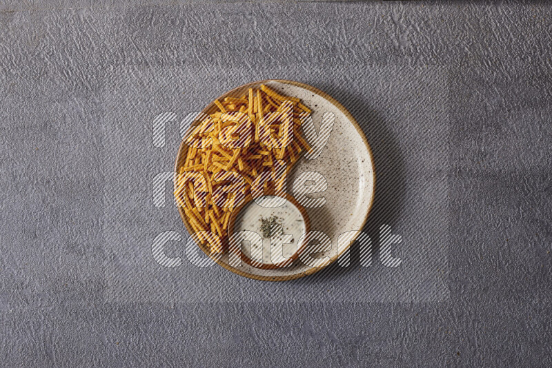 Assorted snacks in pottery bowls on grey background