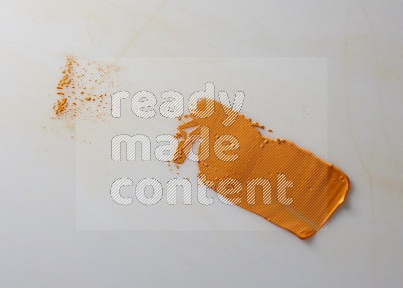 An orange straight painting knife stroke on white background
