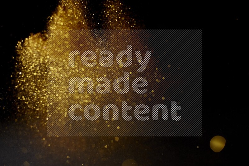 Gold glitter powder isolated on black background