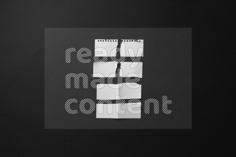 Ripped notebook sheet on black background