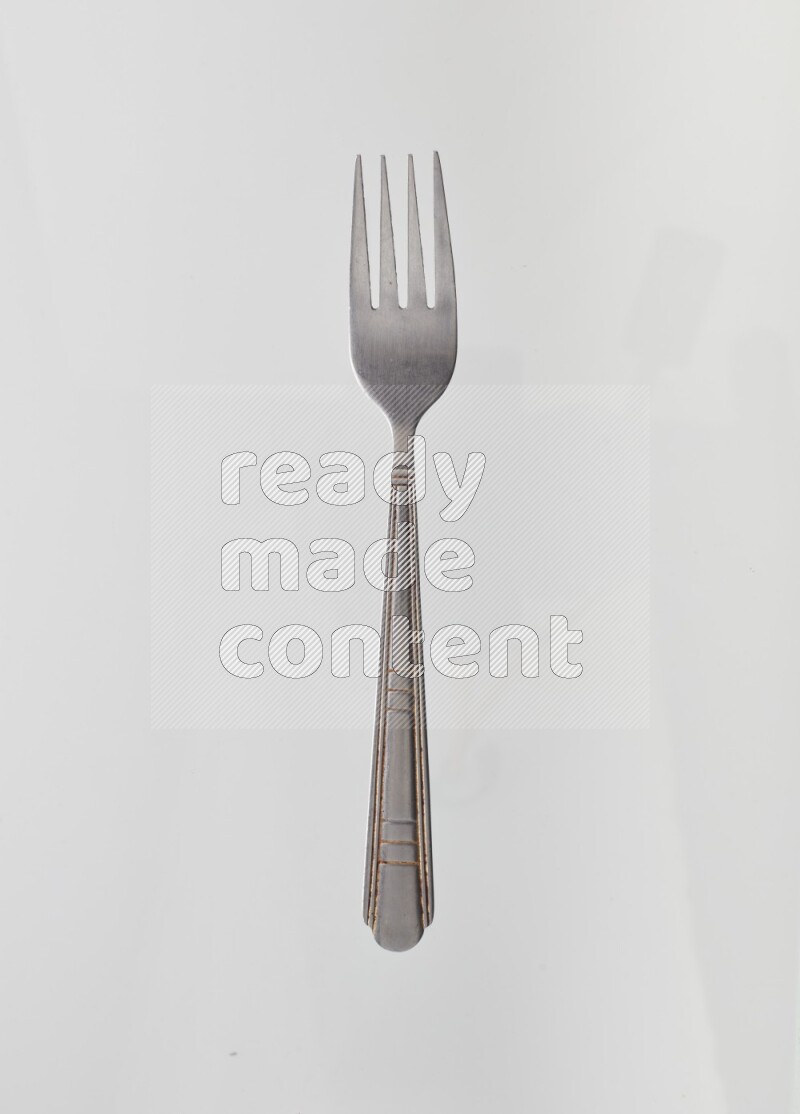 Silver stainless steel fork on white background