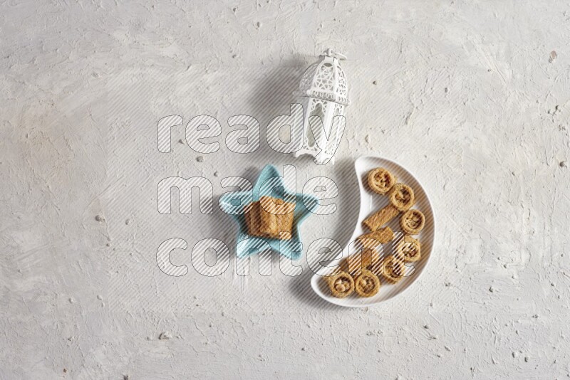 Oriental sweets in a pottery plate with lantern in a light setup
