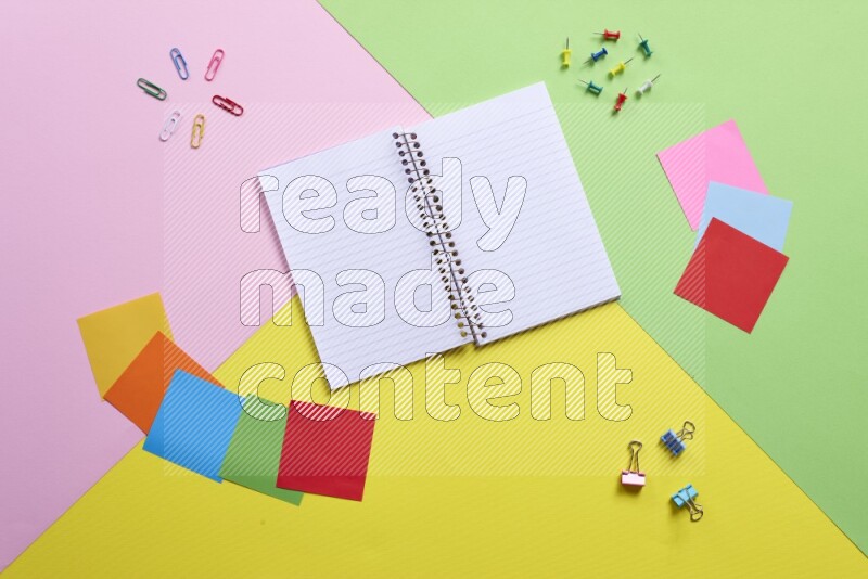 Different school supplies on multicolored background