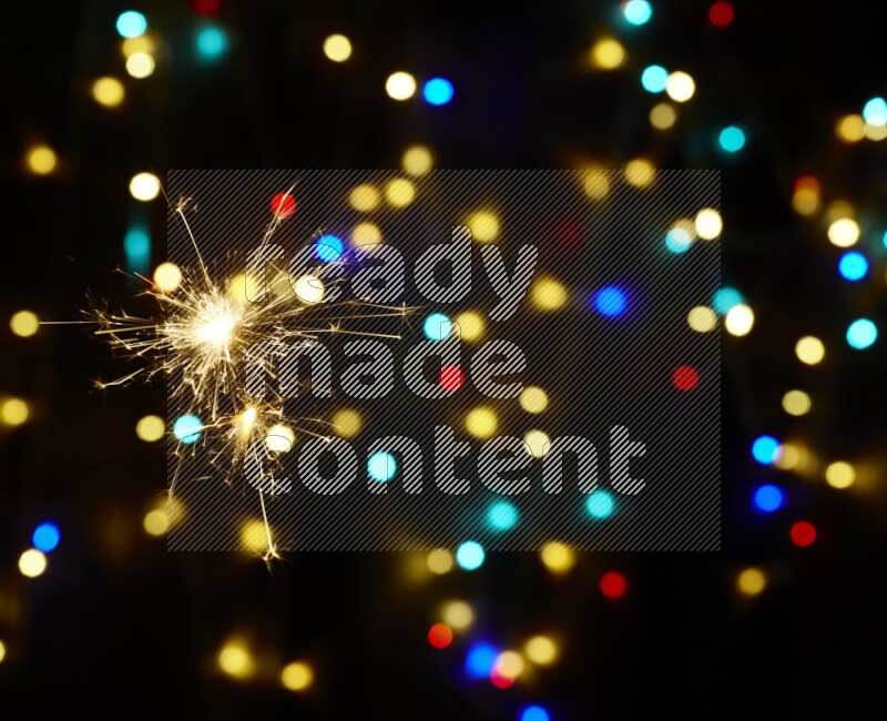 Sparkler candles with multicolored light bokeh background
