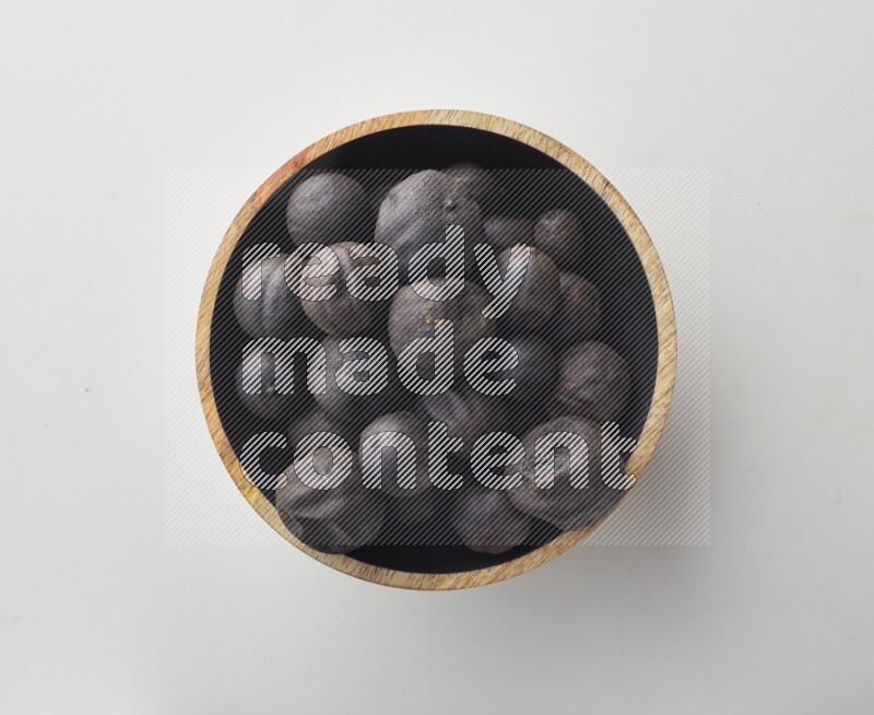 Top-view shot of dried lime (loomi) in a container on white background