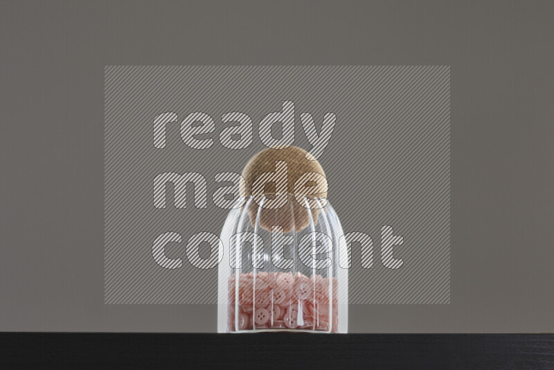 Buttons in a glass jar on black background