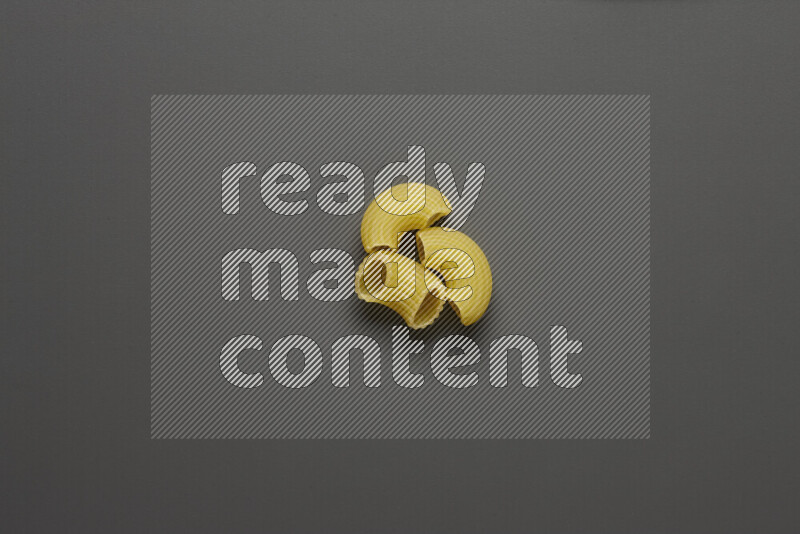 Elbow pasta on grey background